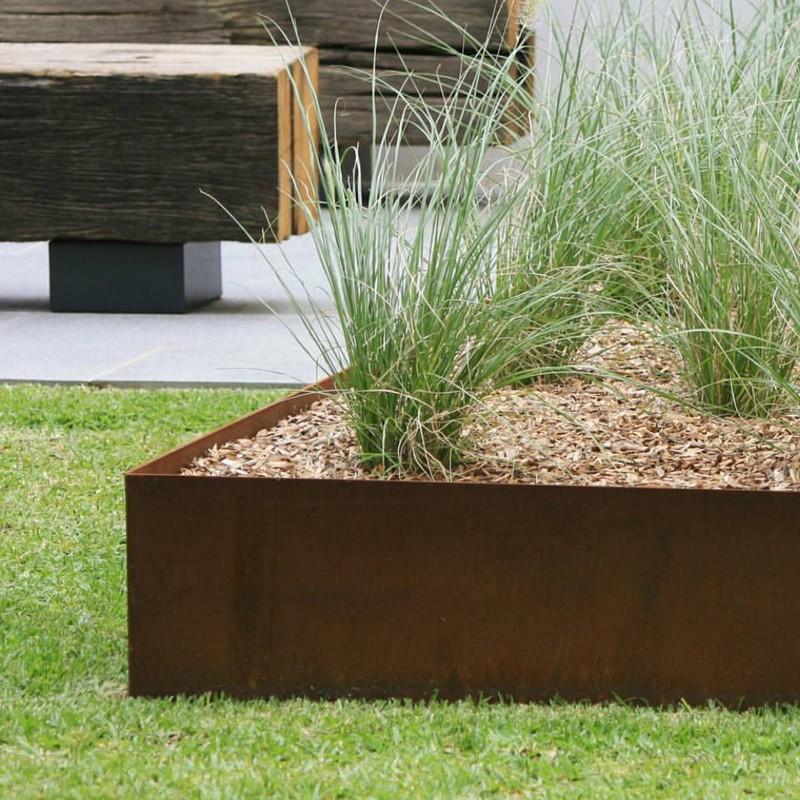 Multi-level steel retaining wall panels creating usable flat lawn space.