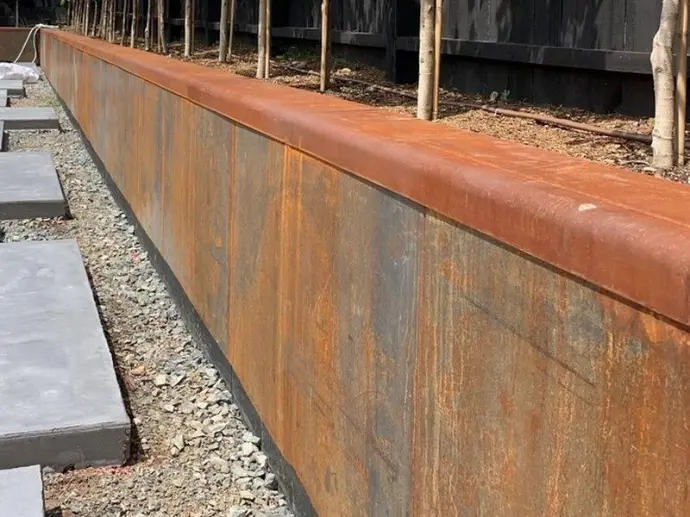 Texture detail of rusted metal retaining walls highlighting orange and brown hues.