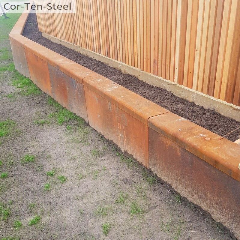 Curved corten steel retaining used to create organic garden bed shapes.