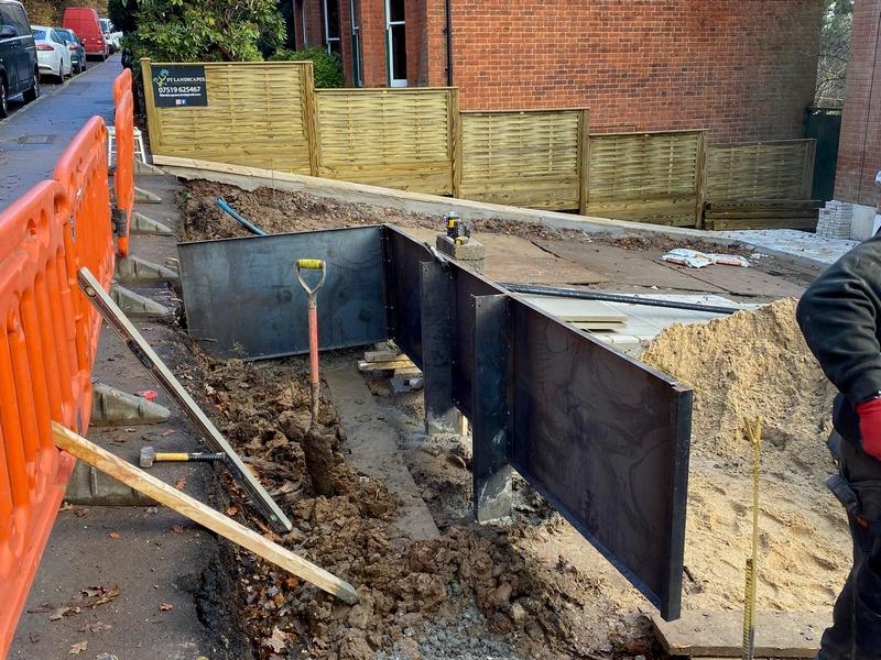 Secure earth retention using slim-line metal retaining walls in wet clay soil.