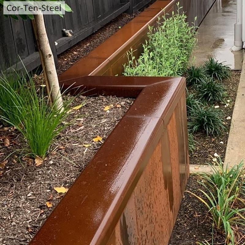 Finished backyard renovation featuring a professional corten retaining wall.