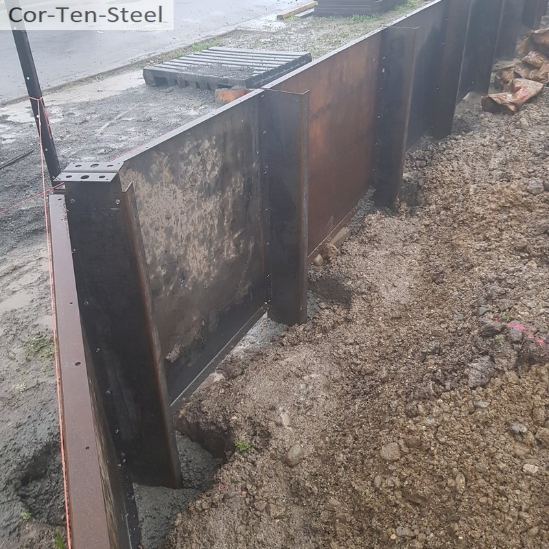 corten steel posts set in concrete pile holes