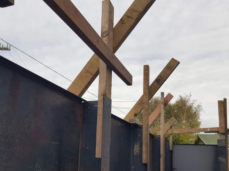 corten support posts braced while concrete sets